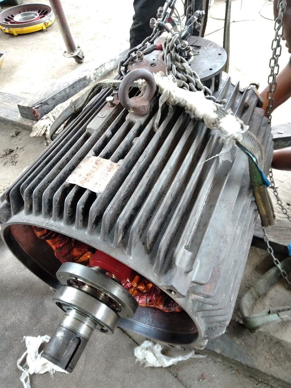 Large industrial motor being lifted for overhaul