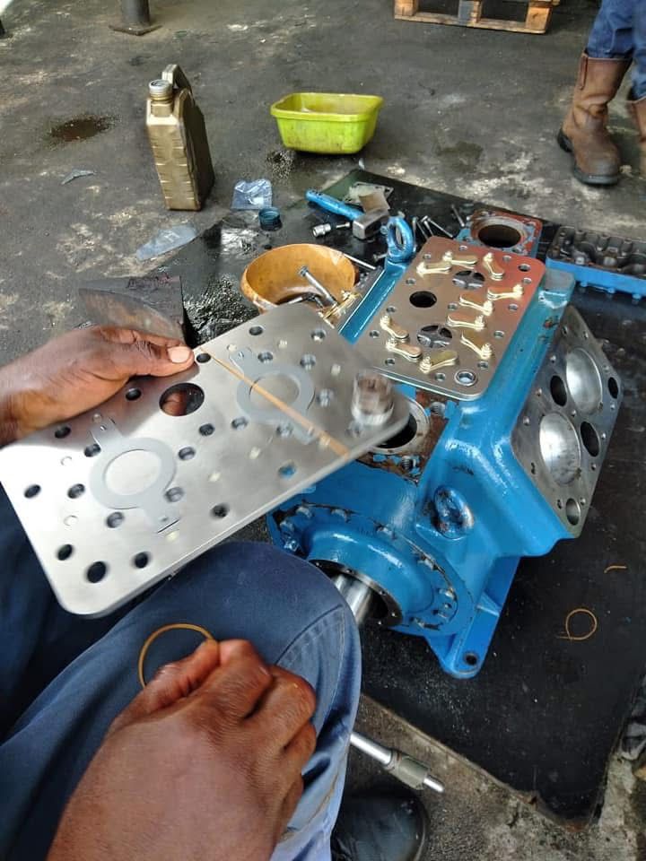 Technician servicing a compressor block